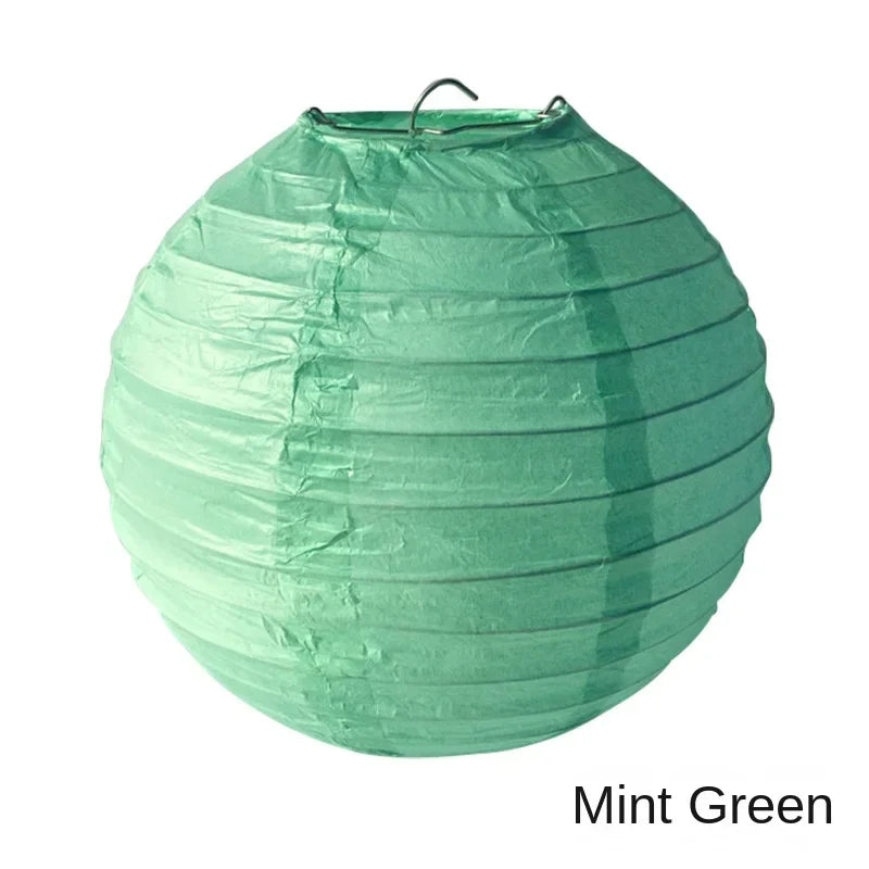 A mint green paper lantern with a gathered, round shape.