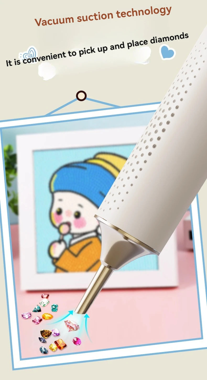 A close-up of a white vacuum suction tool is shown picking up and placing small diamonds onto a piece of art.