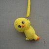A yellow, soft stuffed toy resembling a cartoon animal character is hanging by a yellow strap against a gray background.