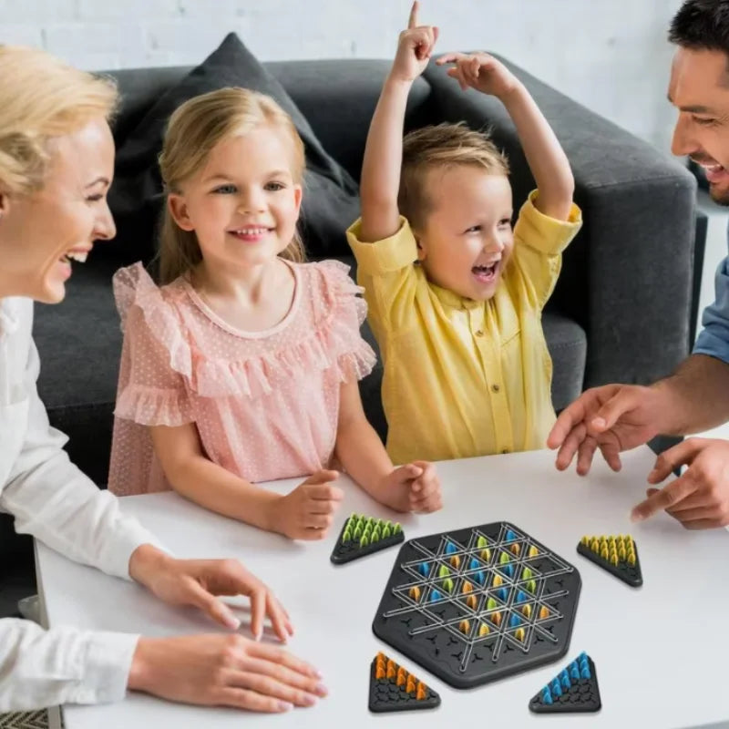 A family is playing the Jumping Pirates Board Game on a table, with game pieces visible.