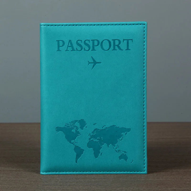 A teal leather passport holder featuring a world map and an airplane icon embossed on the cover.