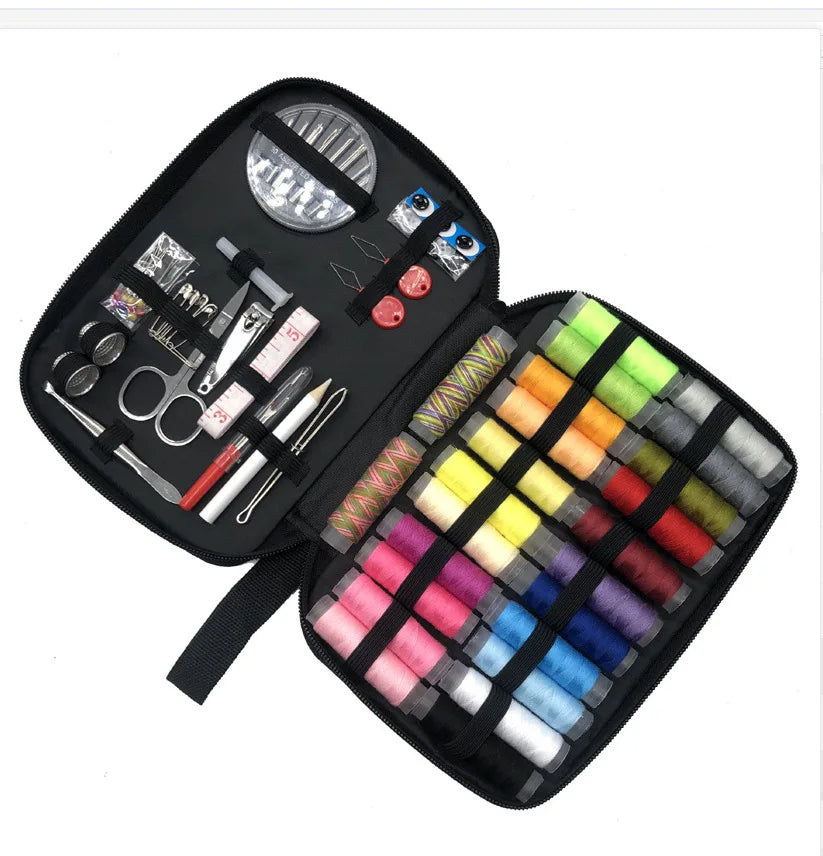 A black portable sewing kit containing various tools like scissors needles and thread spools.