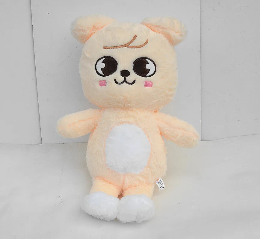 A soft, light orange and white plush toy resembling a cute animal character with large eyes.