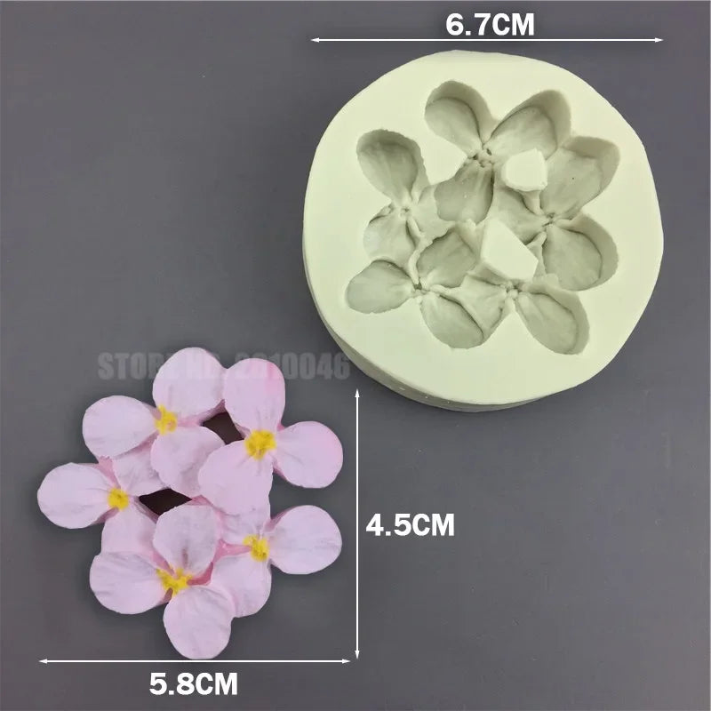 A silicone mold with a flower design, showing the finished pink flowers and the mold itself.