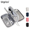 A silver nylon cable organizer travel case with multiple compartments and a matching pink pouch.