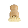 A natural bamboo dish scrub brush with sisal bristles used for cleaning.