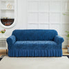 A deep blue zebra print sofa cover with an elastic skirt displayed on a light-colored rug.