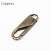 A brass copper zipper pull with a loop and a sliding mechanism.