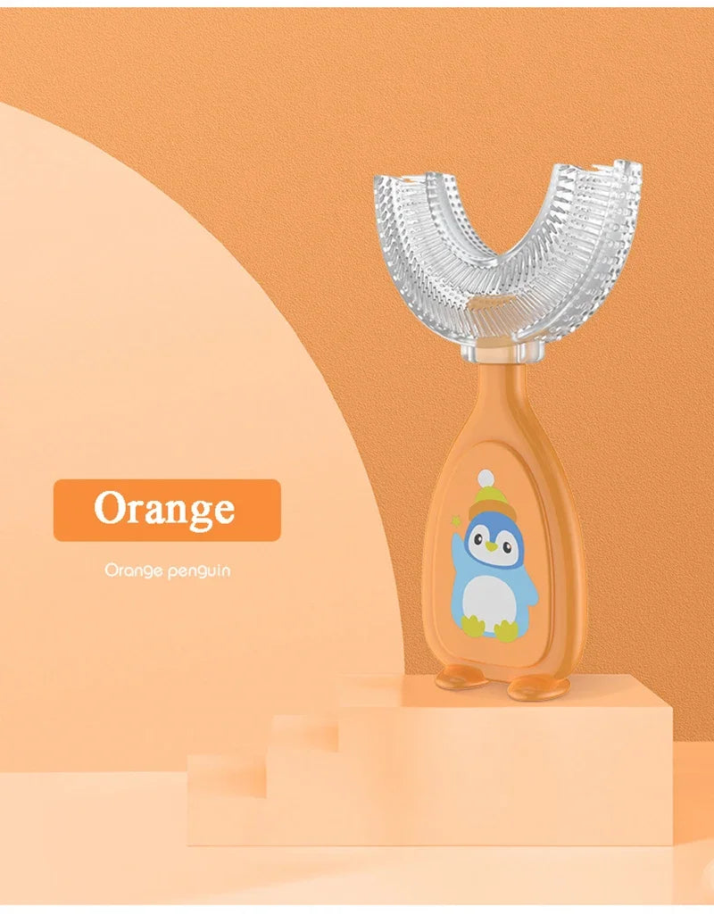 Orange penguin shaped U-shaped silicone toothbrush for kids displayed on a stand.