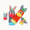 A set of soft baby wrist rattles and foot finder socks featuring colorful patterns and animal faces.
