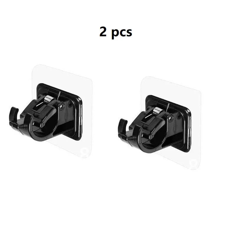 A set of two black no-drill adhesive curtain rod brackets for mounting.