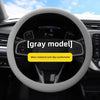A close-up view of a gray steering wheel with a soft silicone cover, emphasizing wear-resistant and anti-slip features.