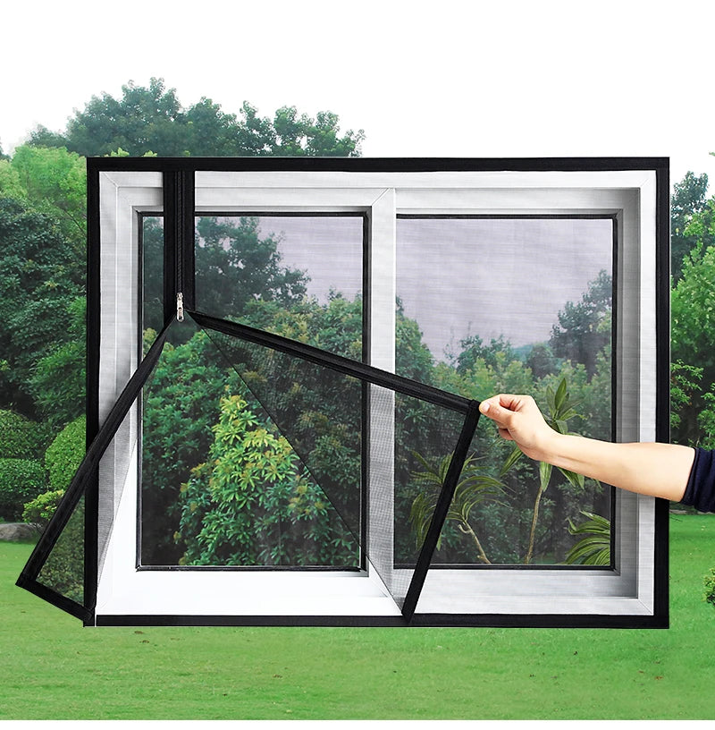 A hand is adjusting a black self-adhesive mosquito net window screen with a zipper on a white frame outdoors.