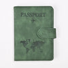 A dark olive green leather passport holder with the word PASSPORT and a world map design.