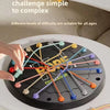 A hand is manipulating a rope challenge puzzle with colored ropes on a black circular board.