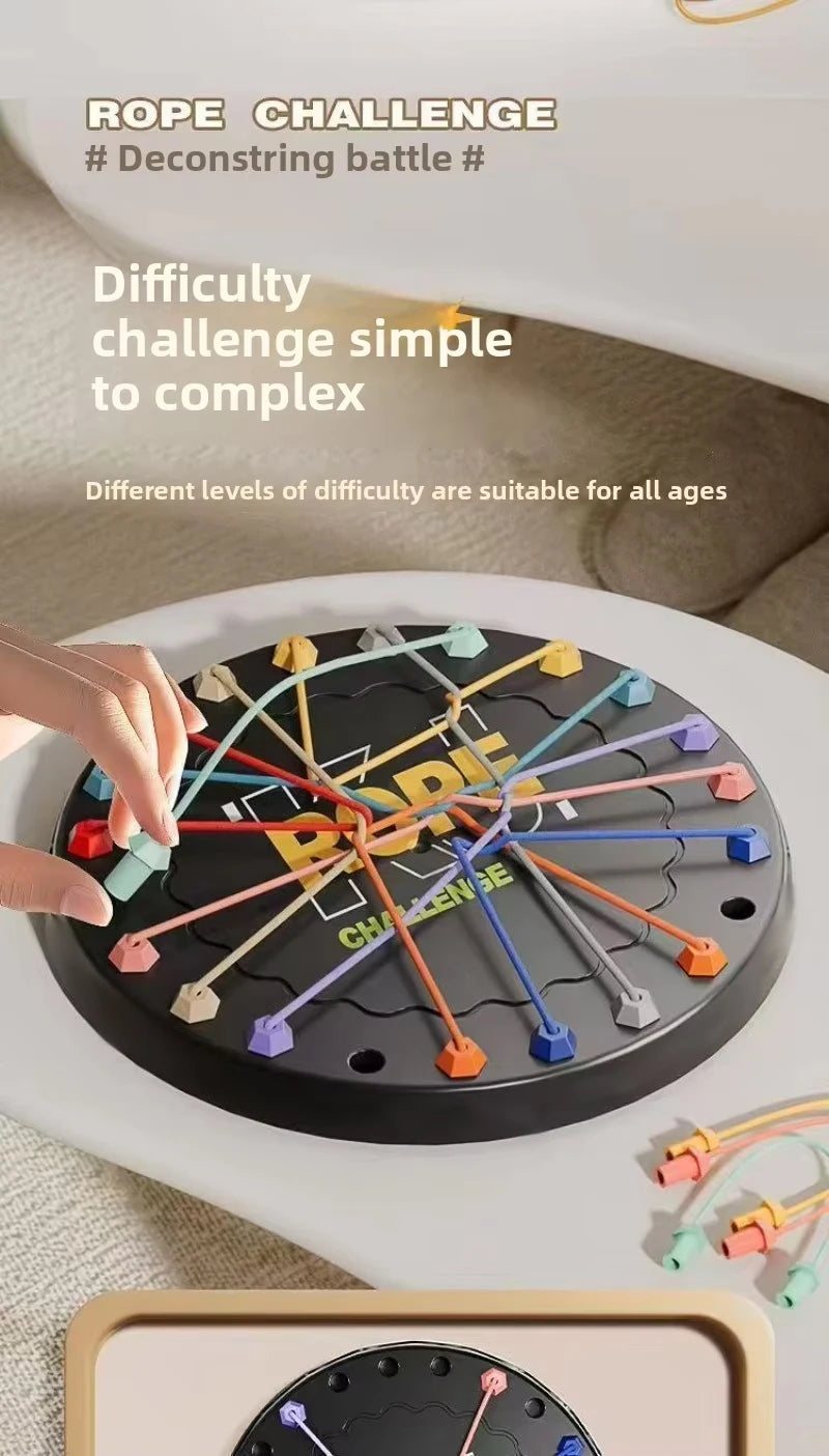 A hand is manipulating a rope challenge puzzle with colored ropes on a black circular board.