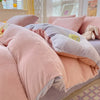A pink and gray cozy milk velvet bedding set featuring a duvet cover and pillows.