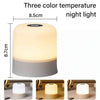 A white touch-activated LED night light is shown in various angles and contexts.