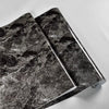 Two sheets of black marble peel-and-stick wallpaper showing dark gray veining.