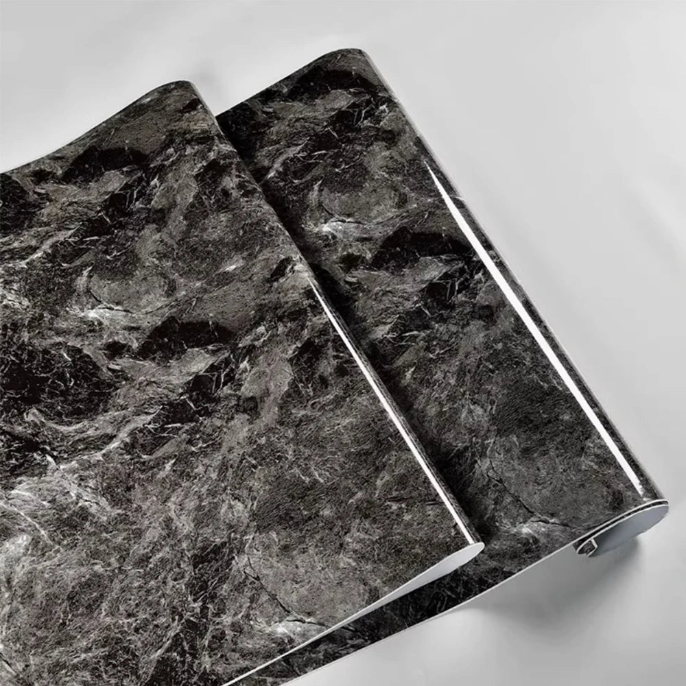 Two sheets of black marble peel-and-stick wallpaper showing dark gray veining.
