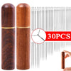 A set of 30 self-threading sewing needles stored in a wooden cylinder with a gold band.