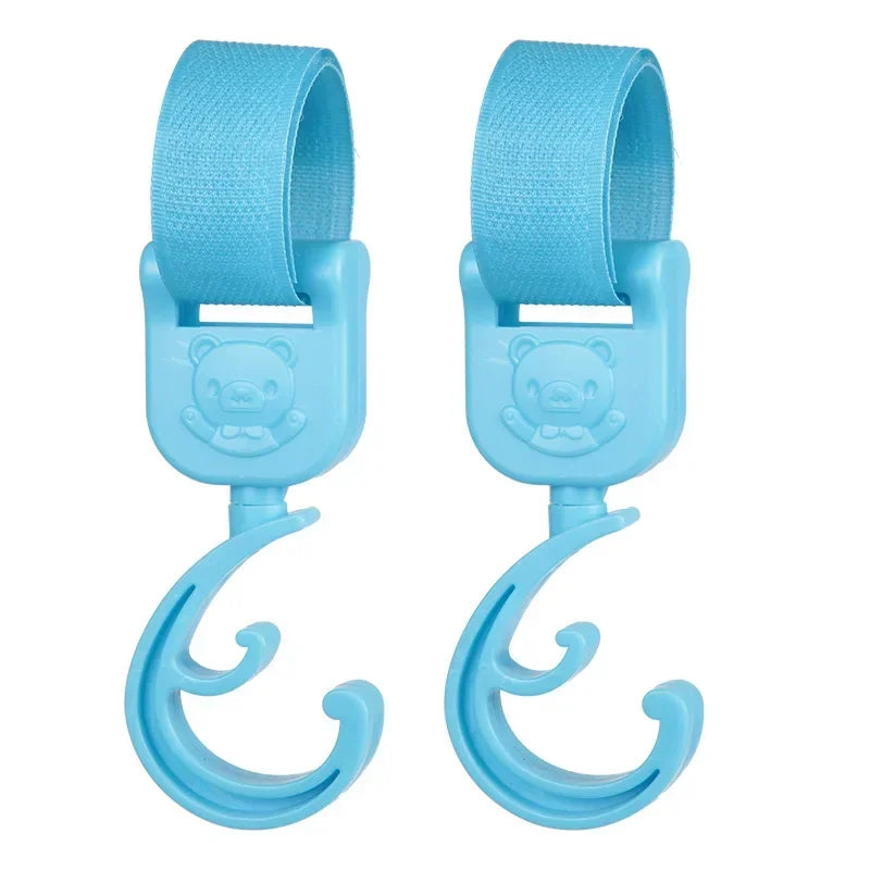 A pair of light blue rotating stroller hooks designed for hanging bags and essentials.