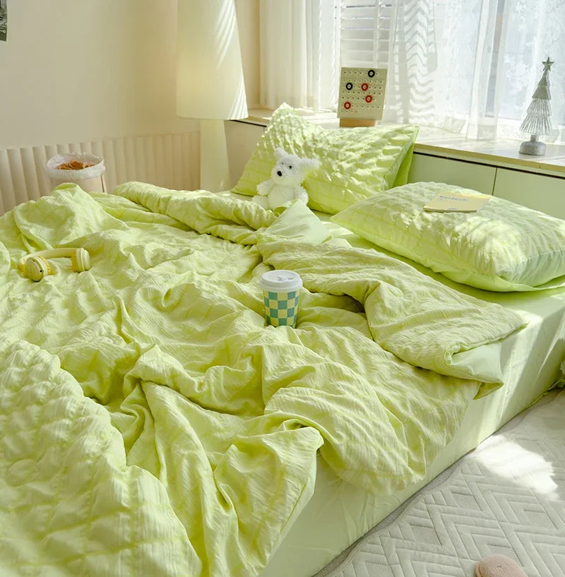 A bright lime green breathable summer seersucker quilt spread out on a bed with white curtains and natural light.
