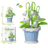 A set of green flower building blocks featuring white flowers, green leaves, and yellow sunflowers in blue pots.