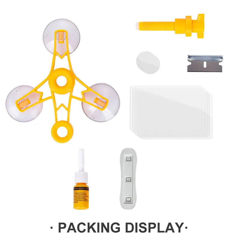 DIY auto glass repair kit components including a yellow applicator, a silver filler, and a white plastic piece.