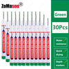 A set of green long markers with red and white tips for woodworking and construction