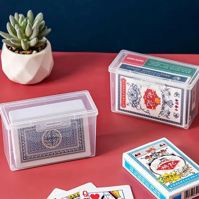 A collection of clear plastic card storage boxes, including one for playing cards and another for business cards, displayed o