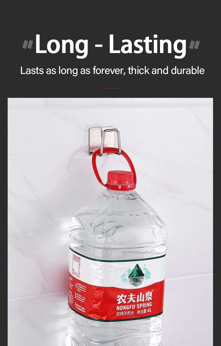 A clear plastic bottle of Nongfu Spring water is hanging on a white wall with a metal hook.