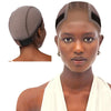 A close-up of a woman wearing a brown lace wig grip cap on her head.