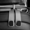 Close-up of car headrest hooks designed to secure bags and shopping organizers