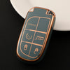 A close-up of a durable TPU car key case cover in a muted green color resting on a dark surface.