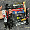 A collection of black and colorful leather keychains featuring various text designs like Stay Positive Night Riders and Save 
