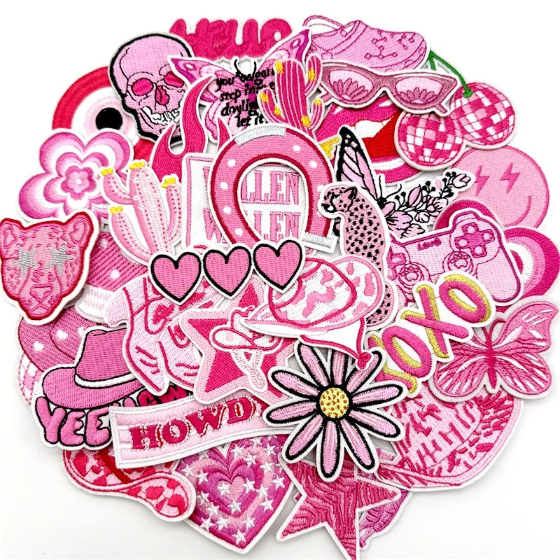 Assorted pink embroidered iron-on patches for DIY clothing and accessories featuring skulls, flowers, and decorative elements