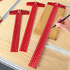 Three red precision aluminum alloy T-rulers for woodworking marking laid out on a wooden surface.