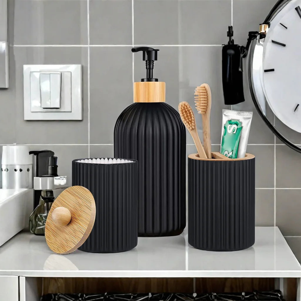 A black bathroom organizer featuring a soap dispenser, cotton storage, and toothbrush holder on a white countertop.