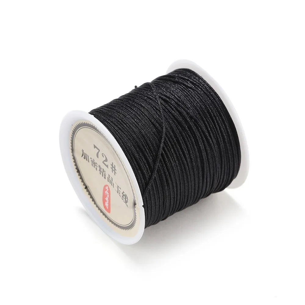 Spool of black 0.8mm nylon macramé cord for jewelry making with a white label.
