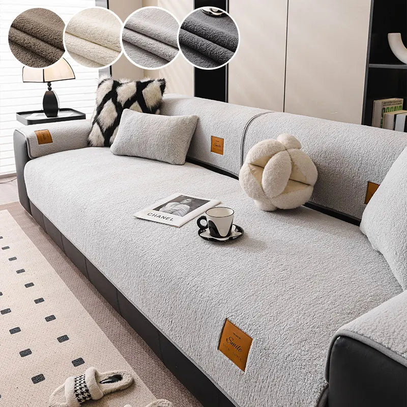 A light gray anti-slip lamb fleece sofa mat with decorative throw pillows and a mug placed on it.