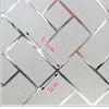 Close-up of a decorative frosted window privacy film featuring a diamond pattern and measurements.