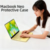 A woman is using a yellow MacBook with a protective case on a white surface.