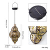 A hanging solar-powered Moroccan lantern with intricate ironwork design and a round solar panel.