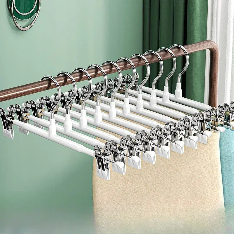 A set of five anti-slip stainless steel hangers with clips for hanging pants and skirts.