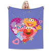 A purple flannel throw blanket featuring a graphic of Elmo and Cookie Monster heads.