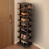 A dark brown stackable vertical shoe rack with multiple tiers holding various pairs of shoes.