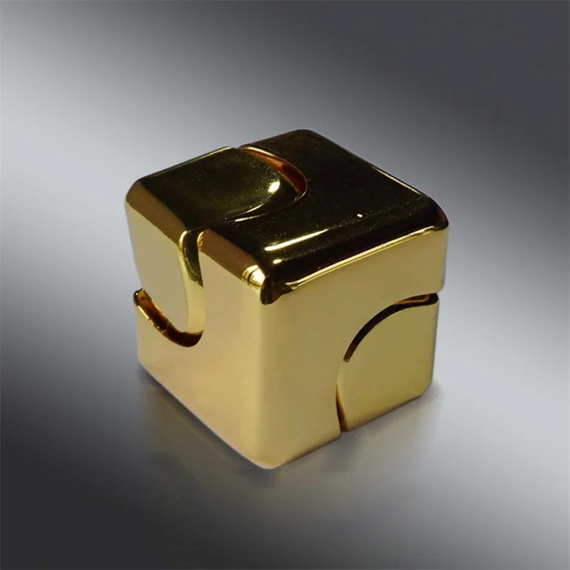 A gold metal fidget spinner cube with a square shape and interlocking features.