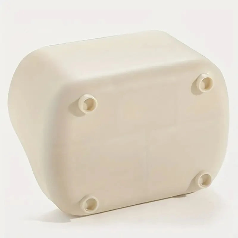 A beige, rectangular desktop organizer with four visible holes on the top surface.