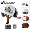 A white motorcycle helmet with a Boss logo and a visor, shown alongside accessories like a cap and leather goods.